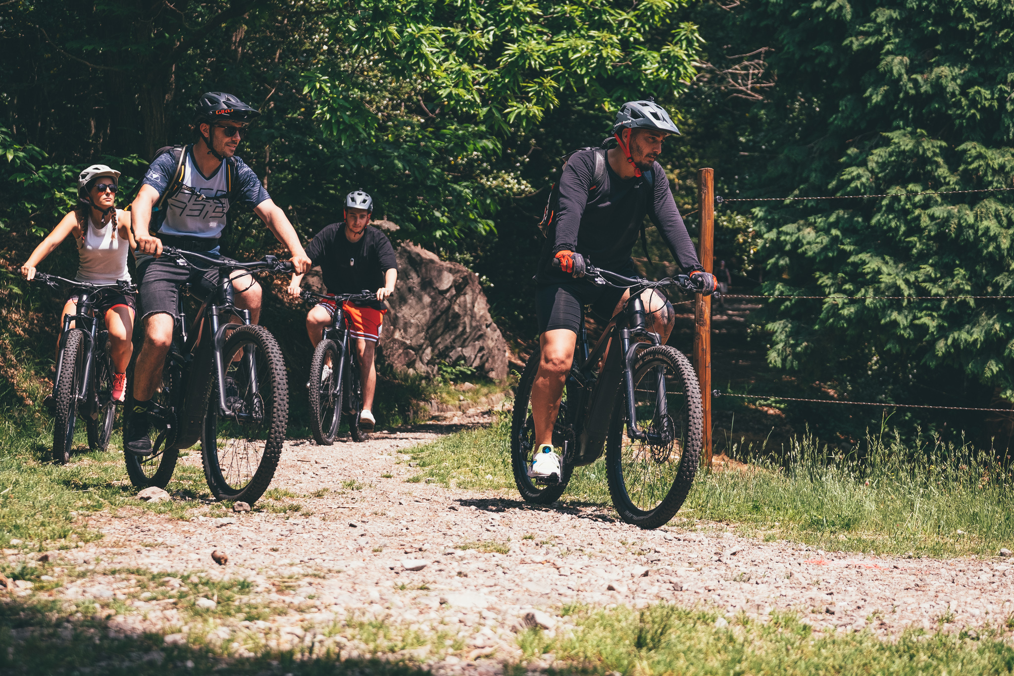 a group of people on a country road in switzerland participate to a bike tour locarno